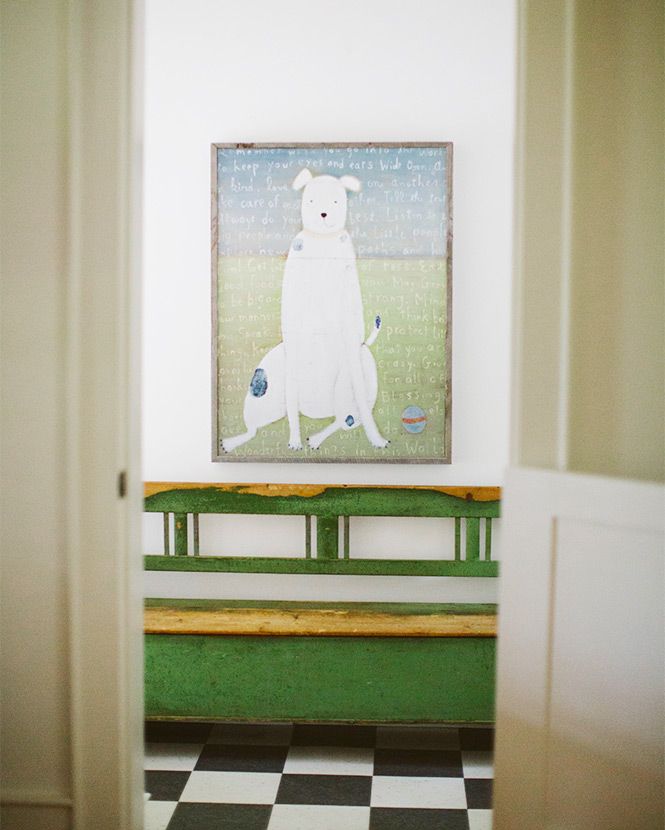 Room with checker board floor and painting of a dog