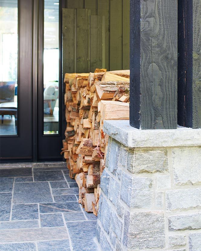 fire wood neatly stacked in a stone-lined entry way