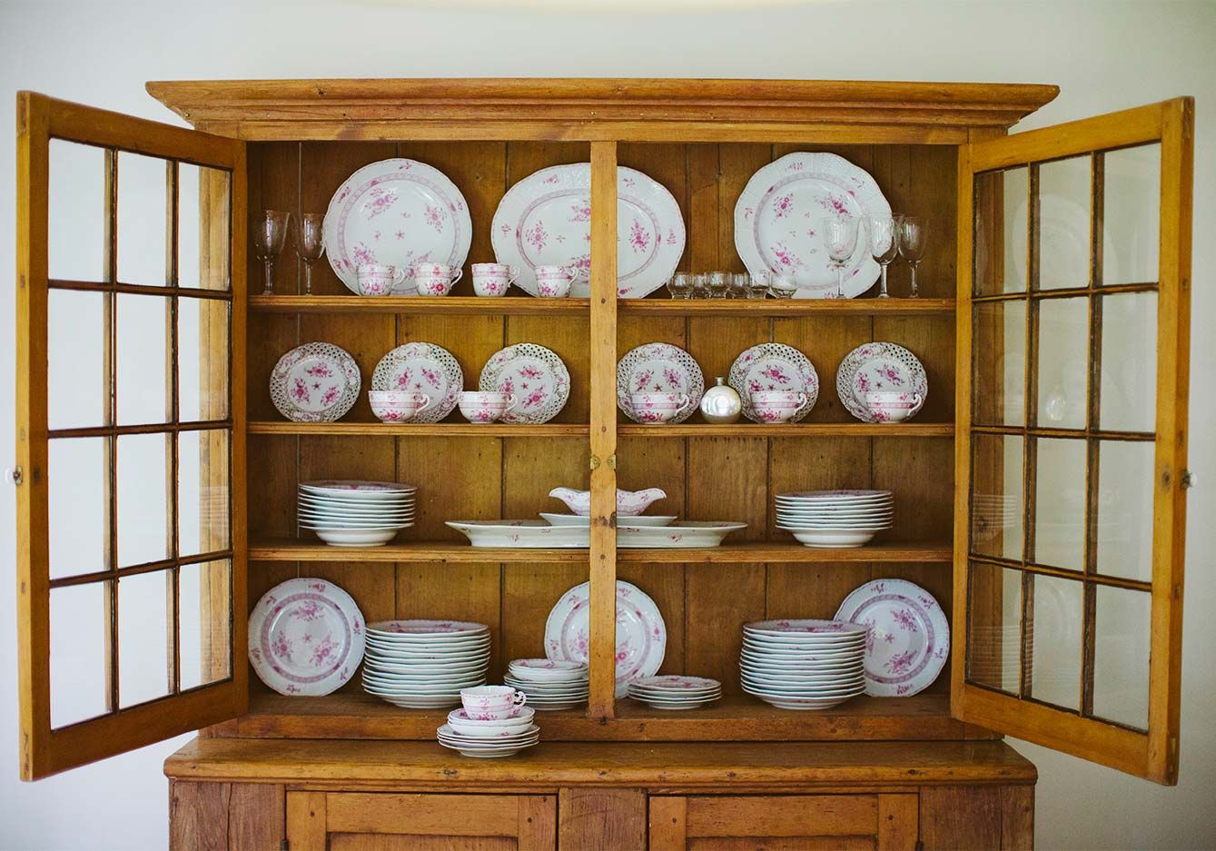 Wooden china hutch with cabinet doors open