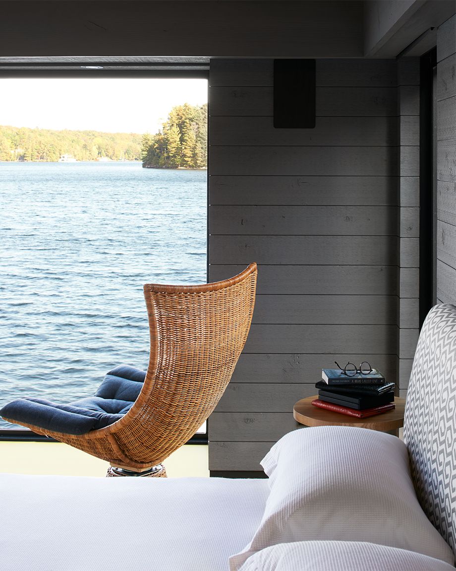 the boathouse - bed with chair overlooking lake